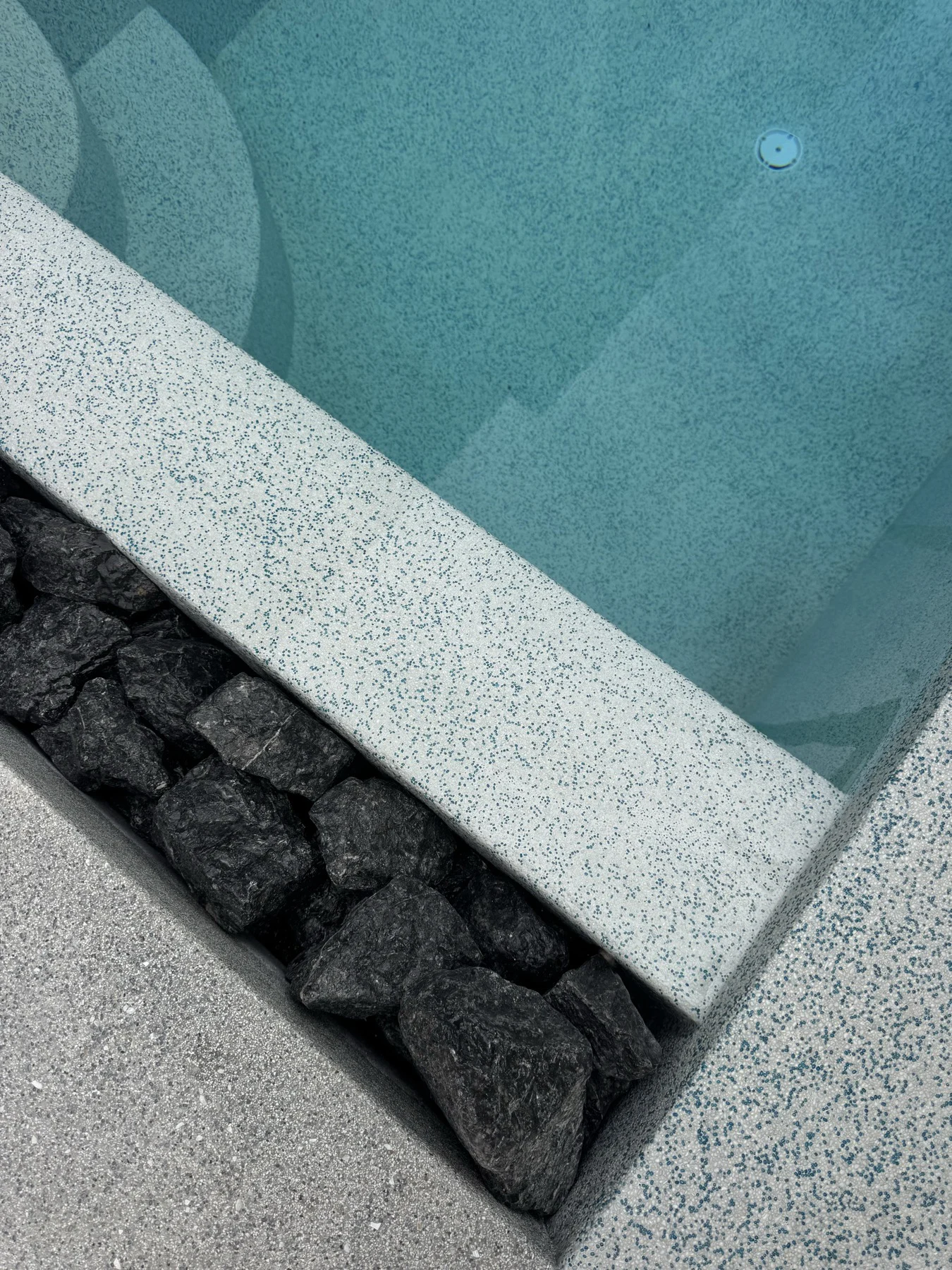 Private Villa, Nai Yang — Atoll Pearl — the pool edge and the black stone channel beside it