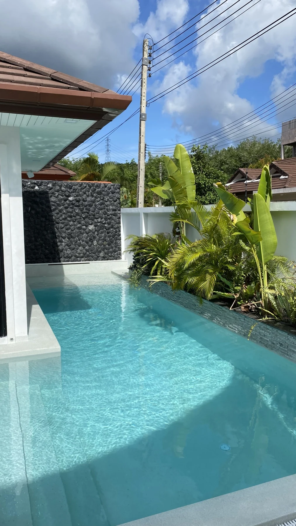 Private Villa, Phuket — the pool and the black marble wall from the entrance