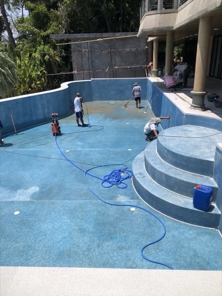 The pool drained and washed down so the surround along its edge could be taken off and relaid
