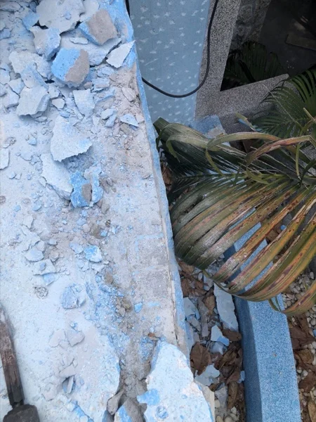 Broken pieces of the old surround lying beside the pool during the strip-out