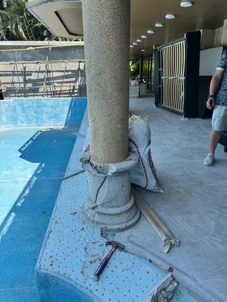 The old surround being broken out around a column of the terrace