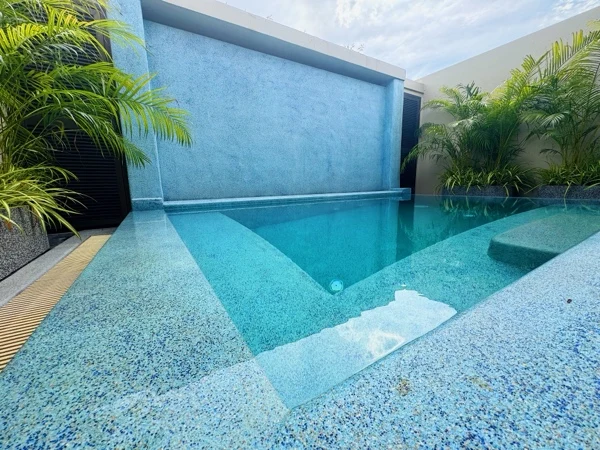 Private Residence, Bang Tao — the waterfall wall reflected in the water