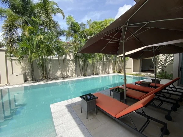 Private Residence, Bang Tao — loungers under the parasols at the pool edge