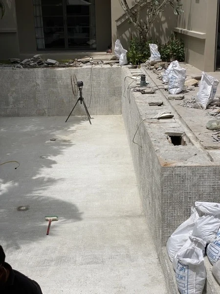 Private Residence, Bang Tao — the wall stripped, the old mosaic left along the top