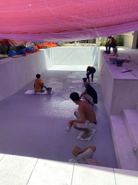 Private Residence, Bang Tao — applying the finish under the shade sheets