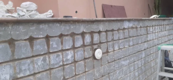 Bayview Lodge — the pool wall stripped back to the blockwork
