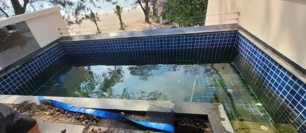 Beachfront Villa, Laguna — the green pool with the overflow channel uncovered