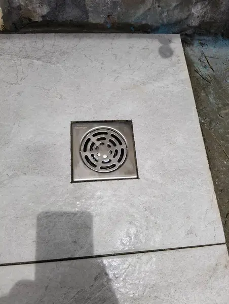 Beachfront Villa, Laguna — a relocated drain set into the new tiles