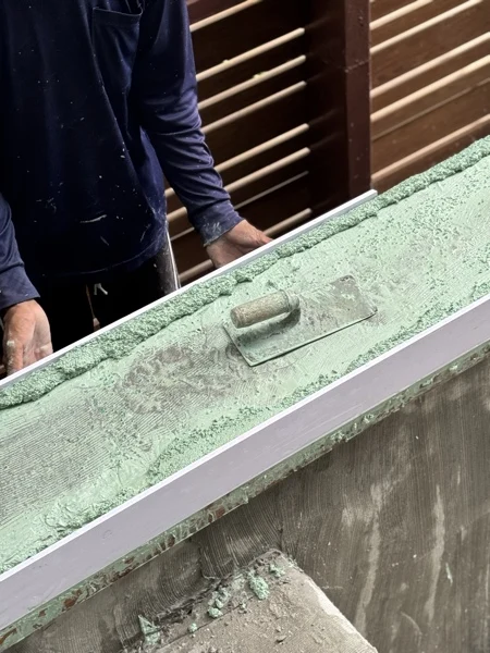 Crest Resort — trowelling the green finish onto the coping