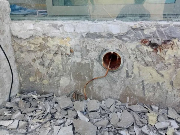 Crest Resort & Pool Villas — the wall taken back to sound concrete