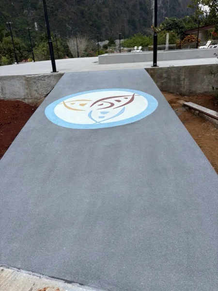 The resort's own logo laid in PebbleCrete in the walkway that leads to the pool