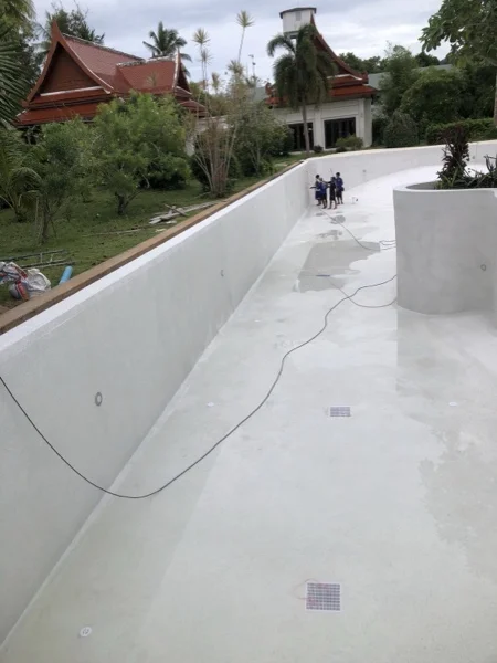 Five-Villa Lagoon Pool — the curved wall and the pool floor before filling