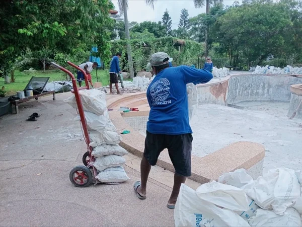 Five-Villa Lagoon Pool — carting the broken-out material off the deck