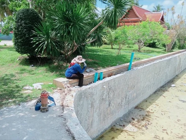 Five-Villa Lagoon Pool — the pool wall at the demolition stage