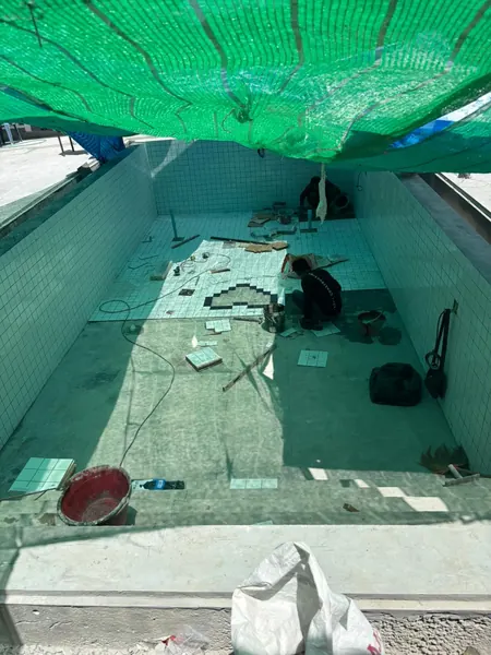 Heart Shape Feature on Pool Floor — the pool under shade netting during the works