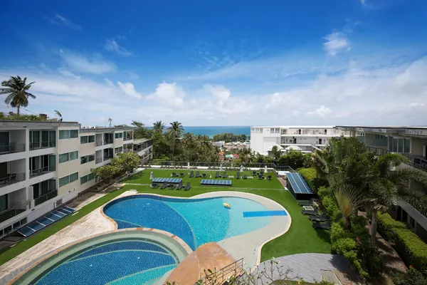 Karon Butterfly Condominium — the pool and gardens with the sea beyond