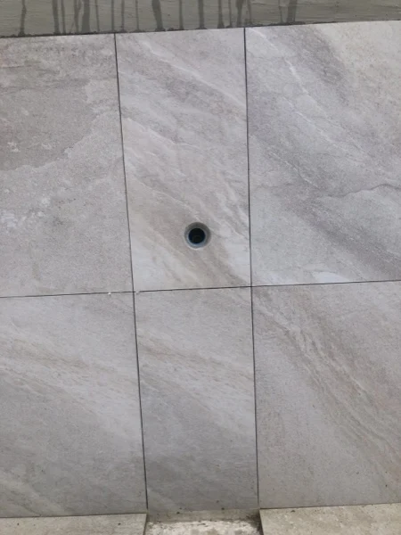 Private Villa, Laguna — a drain set into the large-format tiling