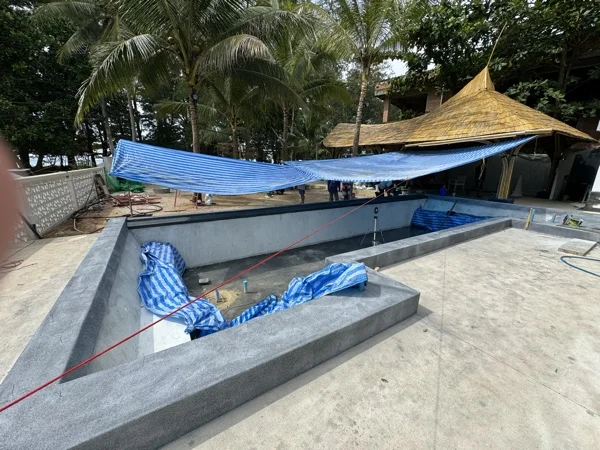 NY Beach Club — the PebbleCrete Glass Nightfall Pearl coping in place, the shell still bare