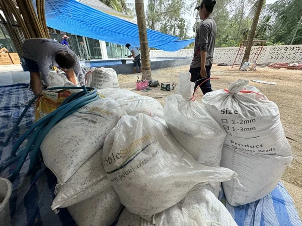 NY Beach Club — bags of aggregate under the pavilion