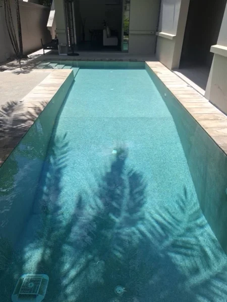 Private Residence, Bang Tao — palm shadows along the pool floor