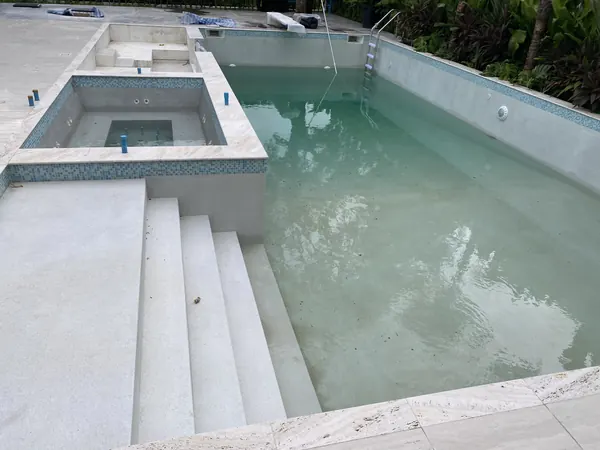 Private Residence, Laguna — the spa and steps, early in the fill
