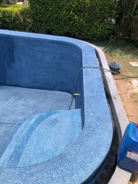 The new finish washed back along the curved wall and floor of the pool