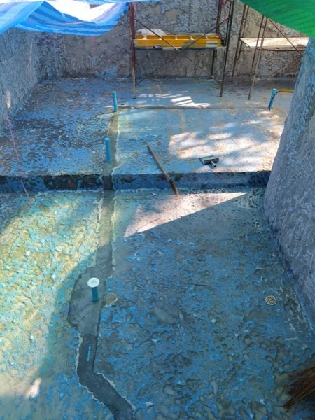 The pool shell with the new pipework fittings set into the floor and walls; the fittings were installed by another contractor
