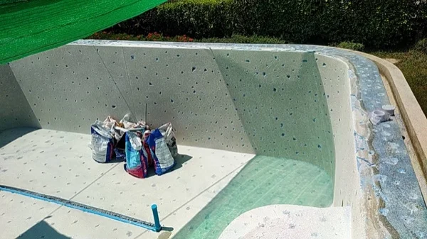 The old marble-based terrazzo finish pocked all over the shell before it was taken off
