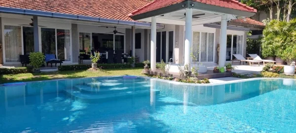 The pool alongside the villa before the renovation, the old finish pale and patchy