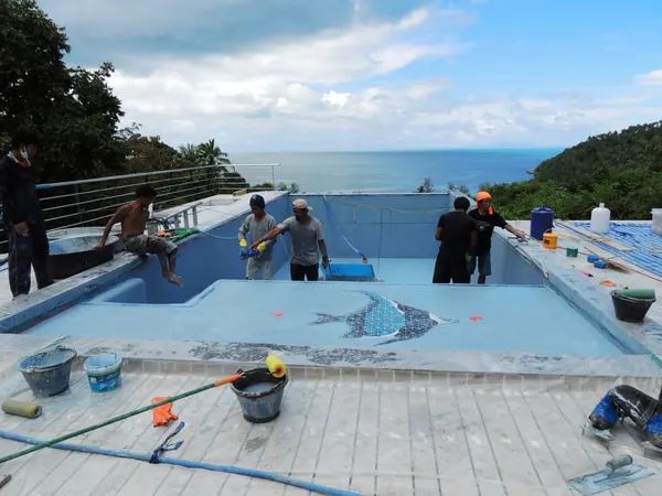 Private Villa, Koh Phangan — crew finishing the floor around the mosaic