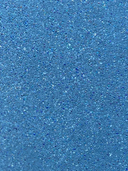 Close view of the PebbleCrete Supreme Royal Blue finish after washing back, with the glass beads exposed