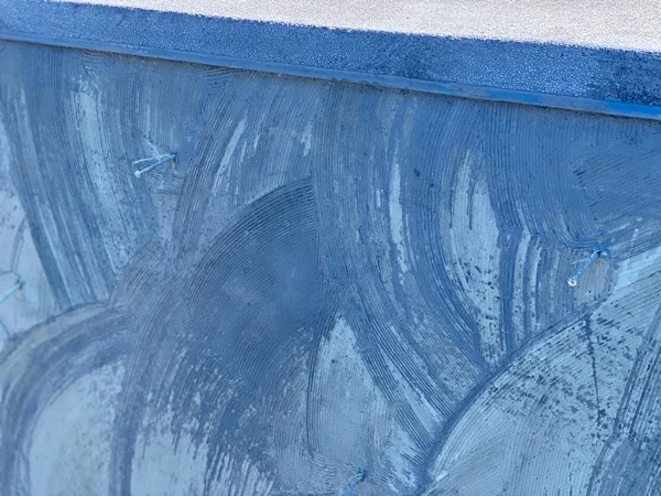 Bond coat being spread across the pool shell before the PebbleCrete Supreme finish is laid