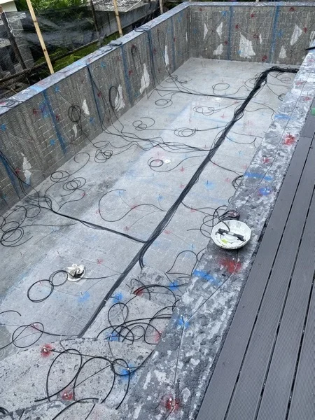 Fibre-optic cable run across the pool shell to every light point before the finish is laid