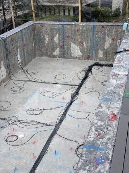 The fibre-optic harness laid out across the floor and walls of the pool shell