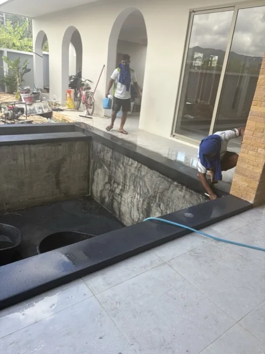 Private Villa, Pasak — the dark coping set around the pool and along the channel