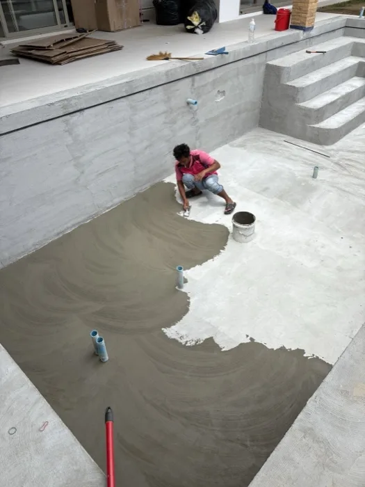 Private Villa, Pasak — spreading the bonding coat across the pool floor