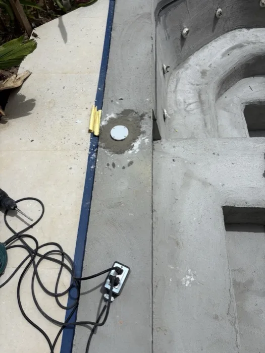Private Villa, Pasak — a light fitting set into the coated wall, the coping masked off