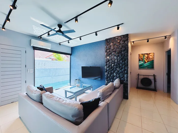 Private Villa, Nai Yang — the custom PebbleCrete Glass wall and the pool beyond