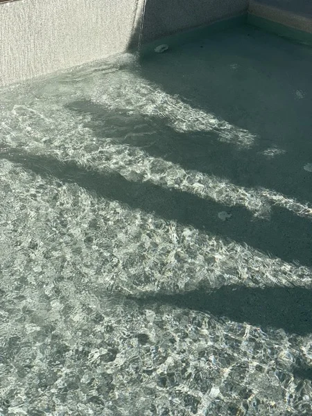 Private Villa, Phuket — water sheeting down the PebbleCrete wall into the pool