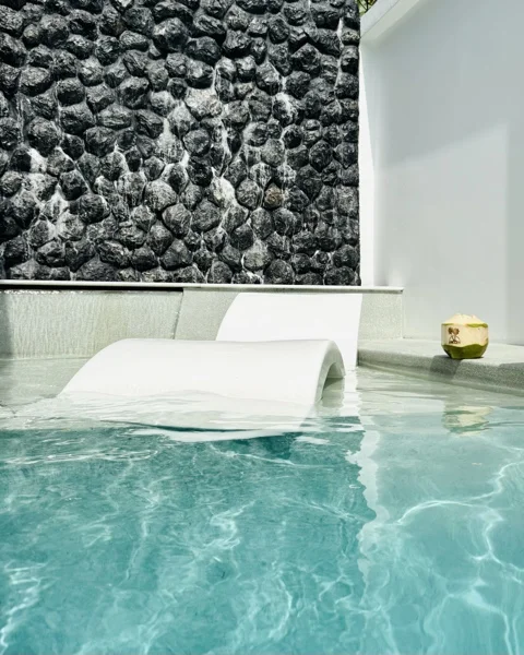Private Villa, Phuket — in-water loungers against the black marble wall