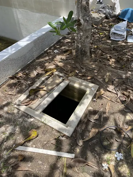 Private Villa, Rawai — Pearl White — a tank opening beside the pool, covered only with boards
