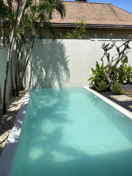 Private Villa, Rawai — Pearl White — the full length of the pool towards the end wall