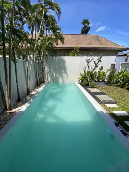 Private Villa, Rawai — Pearl White — the overflow channel and its grating along the pool
