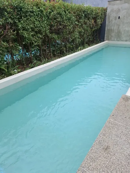 Onyx Villas, Rawai — the pool along the garden hedge