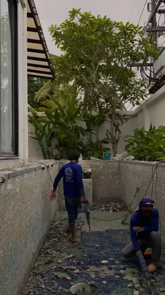 Sea Stone Private Pool Villas — clearing the mosaic from the pool floor
