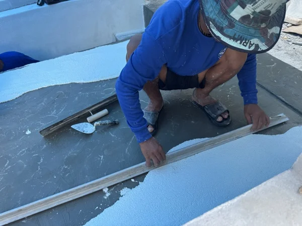Sugar Marina POP, Kata Beach — levelling the applied finish with a straightedge