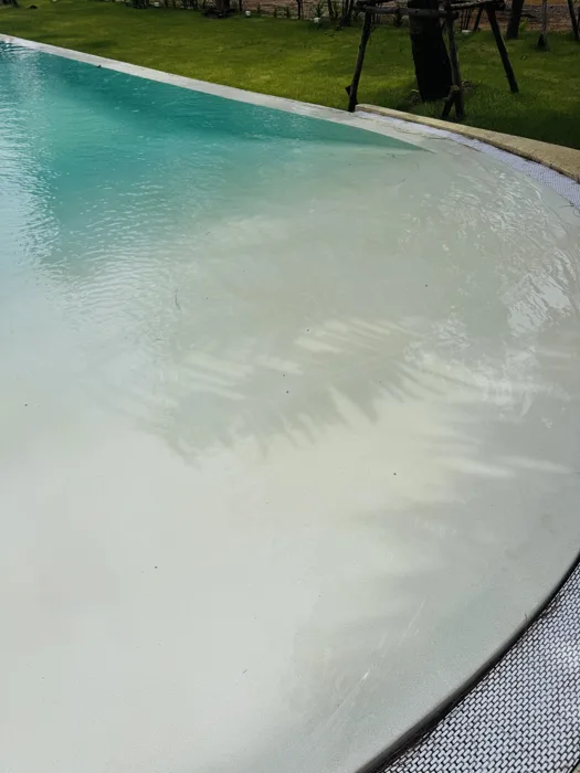 Close view of the broad Pearl White shallow entrance at The Talay, with ripples across the underwater finish.