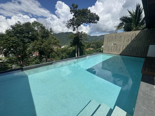 Villa Tantawan Resort, Kamala — a villa pool and the hills
