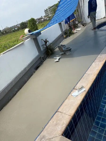 Village Clubhouse — Pool Deck — laying the finish along the pool