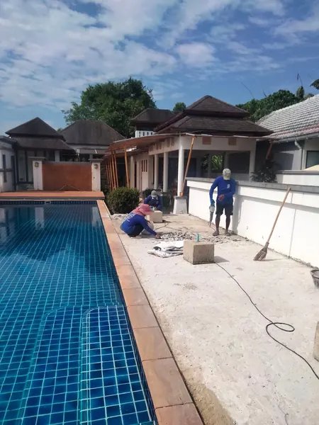 Village Clubhouse — Pool Deck — work on the deck beside the pool